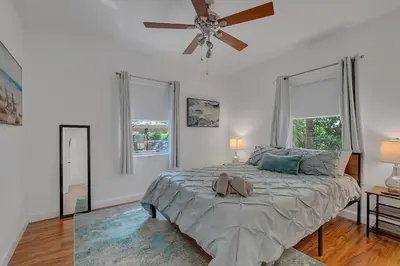 a bedroom with a bed with a ceiling fan at Casa Nikoleta Gated 3Bd 2Bth 10 Min to Beach in Miami