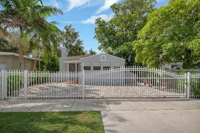 a white picket fence in front of a house at Casa Nikoleta Gated 3Bd 2Bth 10 Min to Beach in Miami