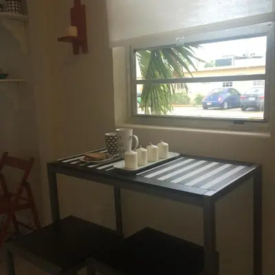 a table with candles on it next to a window at Chic and Comfortable Studio Free Street Parking in Miami