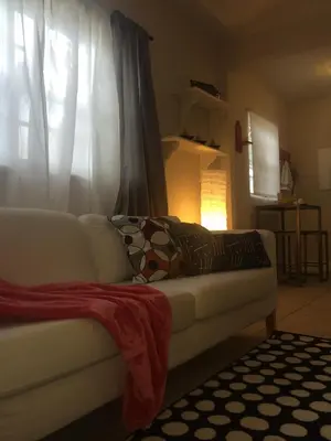 a living room with a white couch and a window at Chic and Comfortable Studio Free Street Parking in Miami