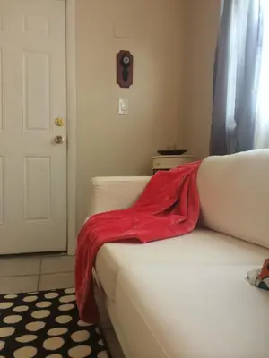 a red blanket sitting on the back of a couch at Chic and Comfortable Studio Free Street Parking in Miami