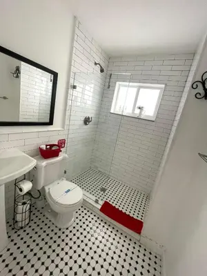 a bathroom with a shower with a toilet and a window at Private Studio blocks from Coconut Grove in Miami