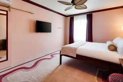 a bedroom with a bed and a tv on a wall at Esme Miami Beach in Miami Beach
