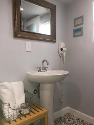 a bathroom with a sink and a mirror on the wall at Private Studio Cabin steps from Calle 8 in Miami