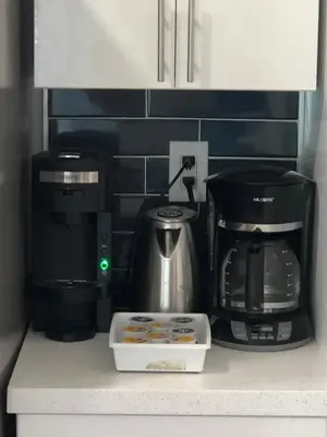 a coffeemaker and coffee maker on a kitchen counter at The Blue Island in Miami Beach