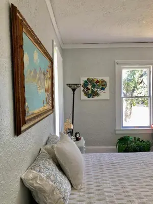 a bedroom with a bed and a painting on the wall at Comfy and Spacious Suite with Free Parking in Miami