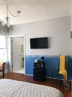 a bedroom with a bed and a tv on a wall at Comfy and Spacious Suite with Free Parking in Miami