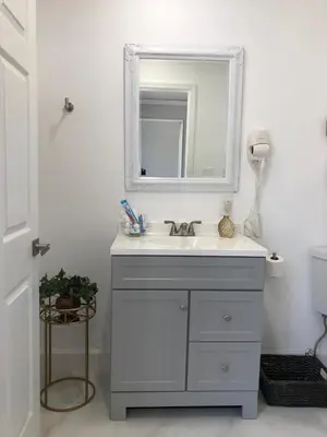 a bathroom with a sink and a mirror at Comfy and Spacious Suite with Free Parking in Miami