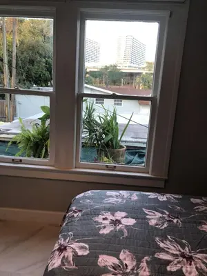 a bedroom with a window with a bed and a view at Cozy Aqua Private Suite with Parking in Miami