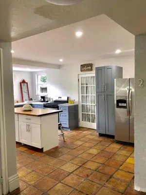 a kitchen with stainless steel appliances and a tile floor at Cozy Aqua Private Suite with Parking in Miami