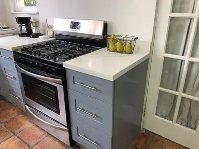 a kitchen with a stove and a counter top at Cozy Aqua Private Suite with Parking in Miami