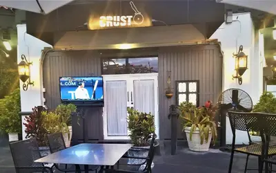 a patio with a table and a tv in a building at Sunny and Charming Suite next to MIA in Miami