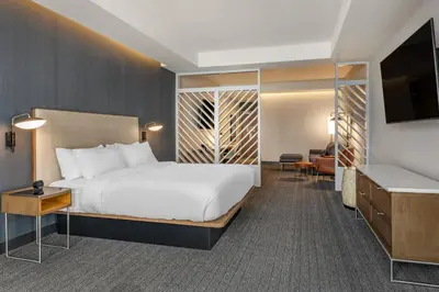 a hotel room with a bed and a flat screen tv at Courtyard by Marriott Fort Lauderdale Downtown in Fort Lauderdale