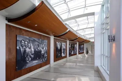 a hallway in a building with pictures on the walls at FB Miami Beach Tresor Private Luxury Suites in Miami Beach