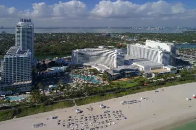 an aerial view of a resort with a beach and buildings at FB Miami Beach Tresor Private Luxury Suites in Miami Beach