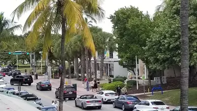 a busy city street with cars and palm trees at 918 SOBE FLATS in Miami Beach