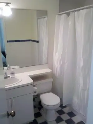 a white bathroom with a toilet and a sink at 918 SOBE FLATS in Miami Beach