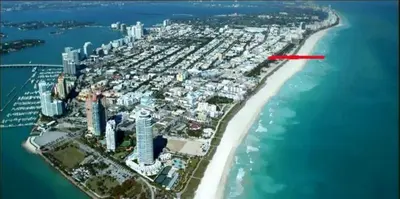 an aerial view of a beach with a red arrow at 918 SOBE FLATS in Miami Beach