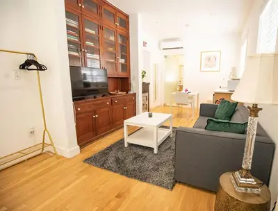 a living room with a couch and a tv at Casa Coral in Miami