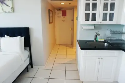 a bathroom with a sink and a bed in a room at Castle 705 in Miami Beach