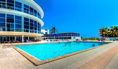 a large swimming pool in front of a building at Castle 835 Oceanview studio on beach with pool, gym, bars, and FREE Parking in Miami Beach