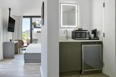 a kitchen with a sink and a microwave at Kaskades Hotel South Beach in Miami Beach