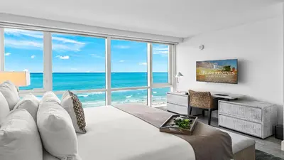 a bedroom with a large white bed with a view of the ocean at Oceanview Private Condo at 1 Hotel & Homes -1120 in Miami Beach