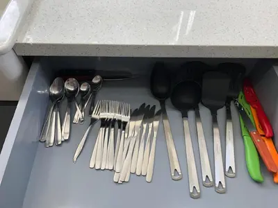 a drawer full of utensils sitting under a counter at Spacious and Comfy Suite near MIA 2 Queen Beds in Miami