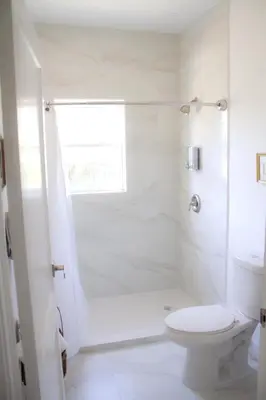 a white bathroom with a toilet and a shower at Spacious and Comfy Suite near MIA 2 Queen Beds in Miami