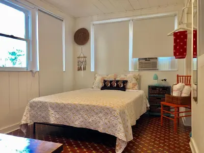 a bedroom with a bed and a clock on the wall at Private Studio with Free Parking in Miami