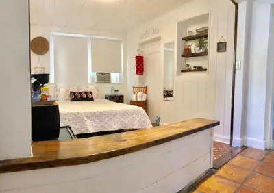 a bedroom with a bed and a kitchen with a counter at Private Studio with Free Parking in Miami