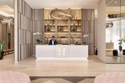 a man standing at a counter in a lobby at Luxury Condo with Jacuzzi and Amenities in Hollywood
