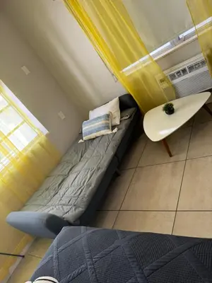 a small room with a bed and a table at Miami International by Lowkl in Miami Beach