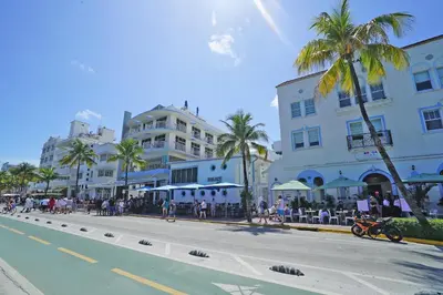 a city street with buildings and palm trees and a road at Deluxe apartments at the Congress in Miami Beach
