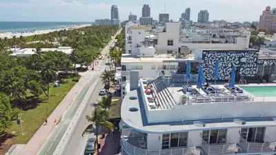 an aerial view of a building with a pool and the beach at Deluxe apartments at the Congress in Miami Beach