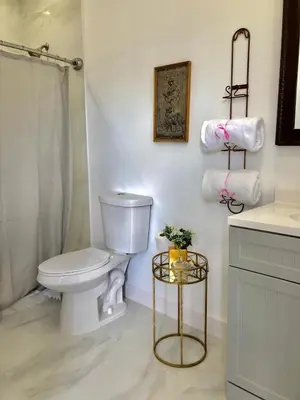 a white bathroom with a toilet and a sink at Private Suite Mins from MIA Free Parking in Miami
