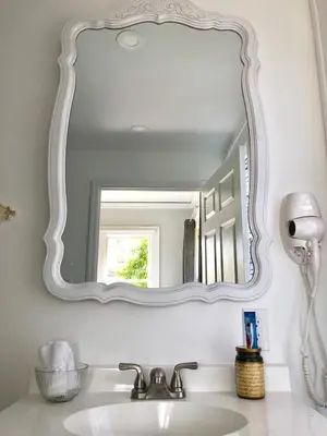 a mirror above a sink in a bathroom at Private Suite Mins from MIA Free Parking in Miami