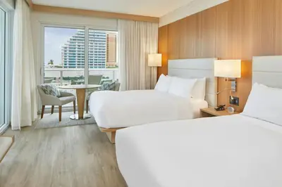 a hotel room with two beds and a window at AC Hotel by Marriott Fort Lauderdale Beach in Fort Lauderdale