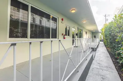 a building with a metal railing in front of it at Boutique Apartments Flamingo in Miami Beach