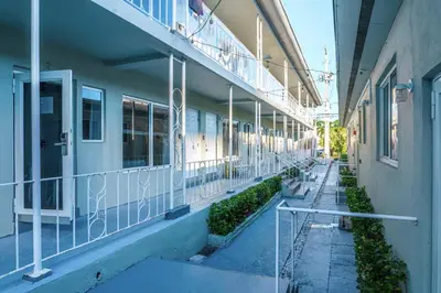 an empty hallway of a building with a balcony at Boutique Apartments Flamingo in Miami Beach