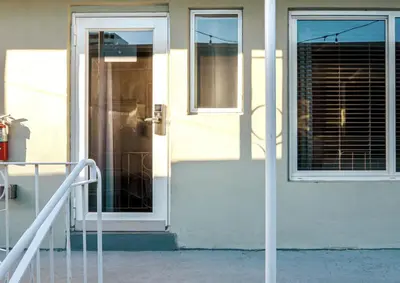 a white door of a house with a window at Boutique Apartments Flamingo in Miami Beach