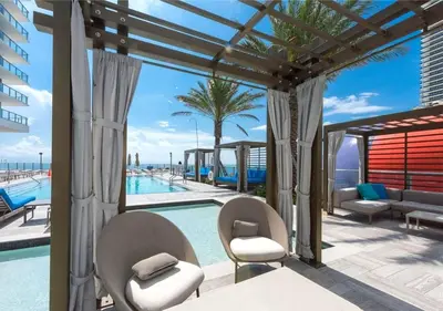 a view of a swimming pool with two chairs and a patio at Life Resort on Miami Hollywood BeachFront by MRA in Hollywood