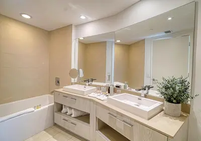 a bathroom with two sinks and a large mirror at Life Resort on Miami Hollywood BeachFront by MRA in Hollywood