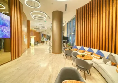 a lobby with couches and chairs and a large screen at Life Resort on Miami Hollywood BeachFront by MRA in Hollywood