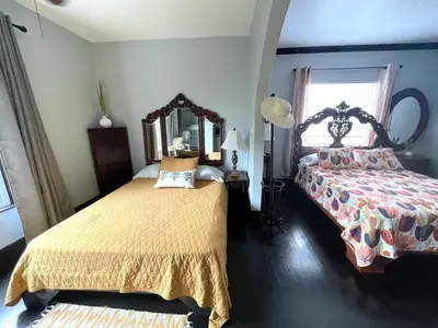 a bedroom with two beds and a mirror at Heavenly Suite in Little Havana Free Parking in Miami