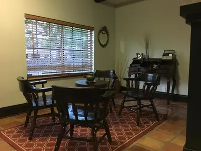 a dining room with a table and chairs and a piano at Private room in the Heart of Little Havana in Miami