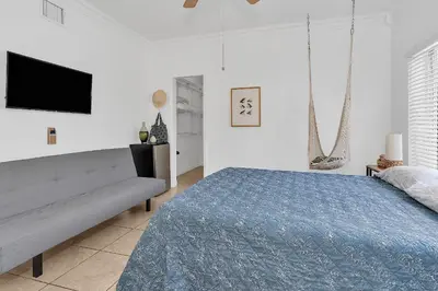 a white bedroom with a bed and a couch at Coral Suite close to Little Havana in Miami