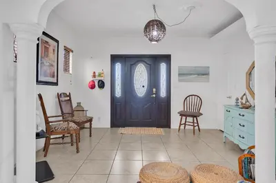 a room with a black door and some chairs at Coral Suite close to Little Havana in Miami