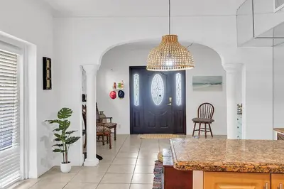 a living room with a blue door and a table at Coral Suite close to Little Havana in Miami