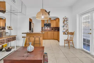 a kitchen with wooden cabinets and a vase on a table at Coral Suite close to Little Havana in Miami